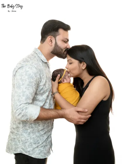 A slightly different angle of the first family portrait, showing the complete embrace. These simple, clean studio shots keep all the focus on the love and connection of the new family.