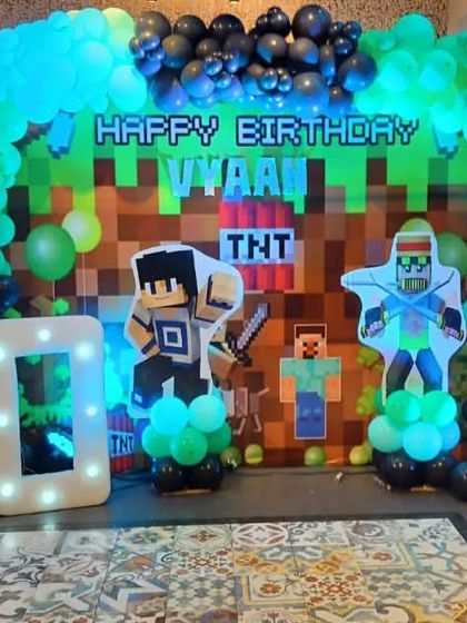 The full Minecraft stage setup, complete with character props, a TNT block design, and a light-up "10" for the birthday boy.