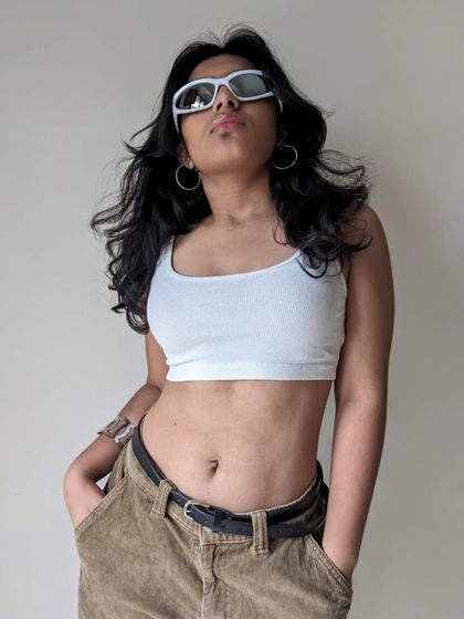 Another angle from the "Phoenix" photoshoot, showing off the windswept hair and cool sunglasses.