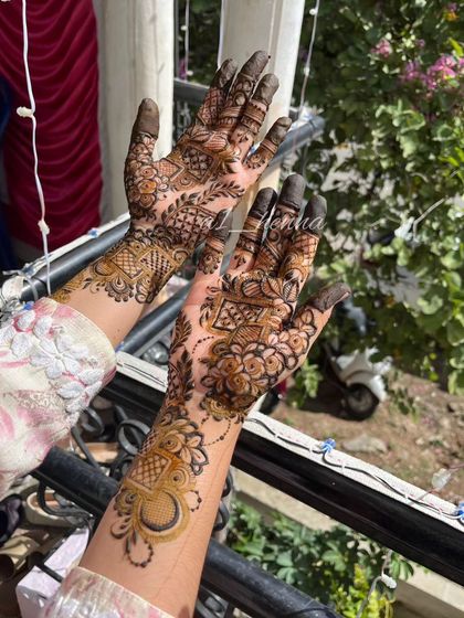 A stylish party henna design with a mix of geometric and floral elements.