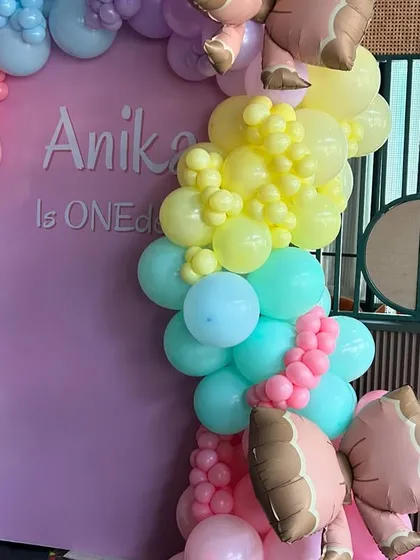 A detail of the pastel rainbow balloon arch, featuring ice cream cone balloons for an extra touch of sweetness.
