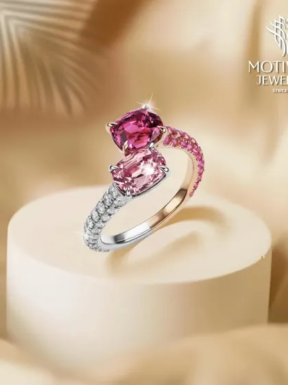 A contemporary two-stone ring featuring pink tourmalines in different shades, accented with a band of sparkling diamonds. A modern and colourful statement.