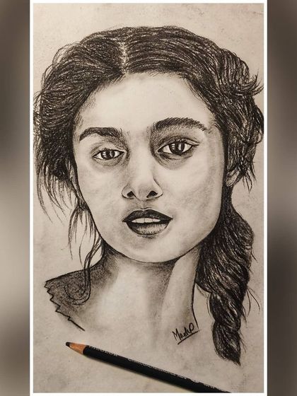 A charcoal portrait demonstrating how I build up texture and tone to create realistic hair and capture a specific expression. Every detail matters in bringing a portrait to life.