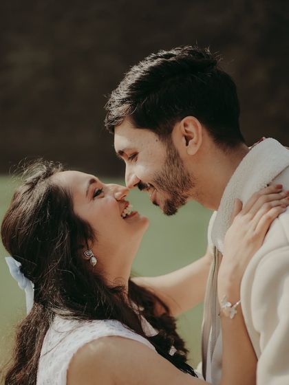 An adorable close-up of a couple sharing a happy, nose-to-nose moment.