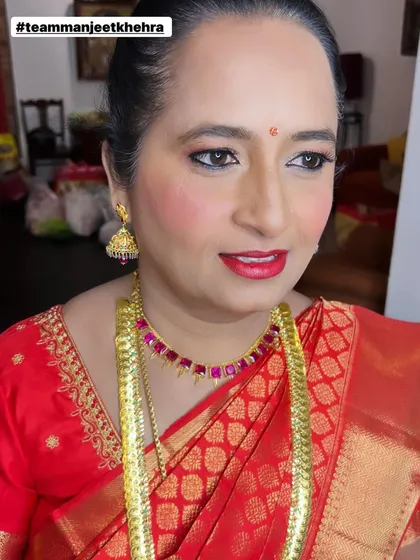It’s an honor to get the mother of the bride ready for the big day. For her reception, we chose a graceful and elegant look with a soft shimmer on the eyes, a classic red lip, and glowing skin that looks beautiful both in person and in photos.