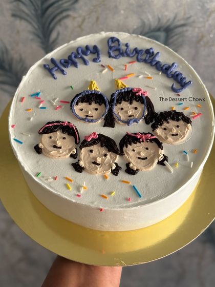 A sweet and simple custom cake featuring hand-piped faces of friends or family, perfect for a close-knit birthday celebration.