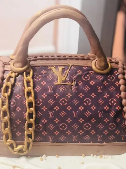 A slice of luxury you can actually eat. This 3D sculpted cake is a detailed replica of a classic Louis Vuitton handbag, perfect for the fashion lover who appreciates edible artistry.