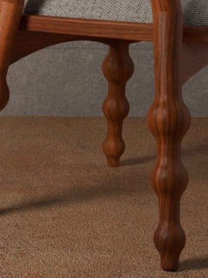 A series of images detailing the Manjadi chair, from its hand-turned legs inspired by the seed pod to the vibrant red upholstery. These shots highlight the craftsmanship and the deep cultural narrative behind this unique design.