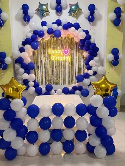 A similar blue and white cake table decoration, this time with a gold foil curtain backdrop.