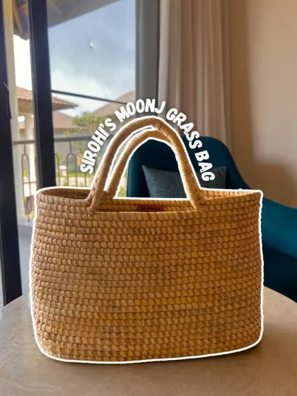 A handcrafted treasure. This beautiful Moonj grass bag from Sirohi is a perfect example of sustainable style. It's a versatile piece that adds an earthy, artisanal touch to any outfit.
