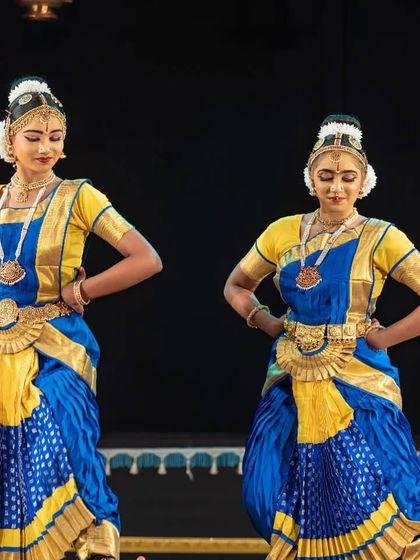 Two students in a graceful pose during the Allaripu at Nrithya Milanam 2022. The matching costumes and synchronized movements reflect the discipline and unity of our school.