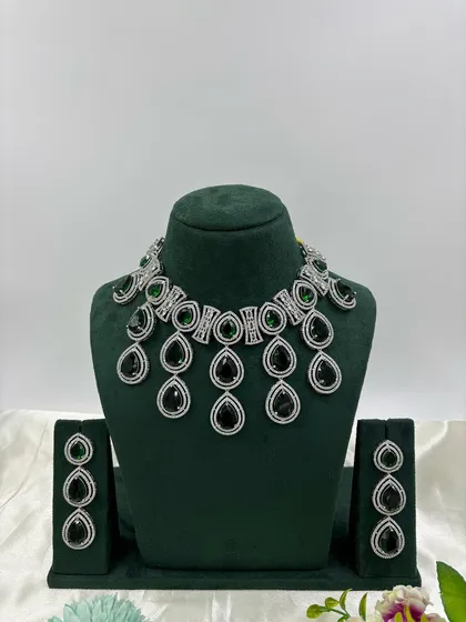The teardrop necklace with black stones.
