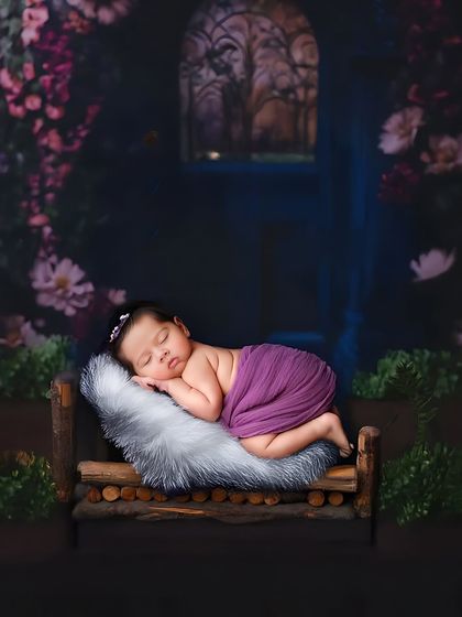 A fairytale-like scene with a baby sleeping on a rustic wooden bed in an enchanted forest setting. This shows the creative backdrops I can use to bring a theme to life.
