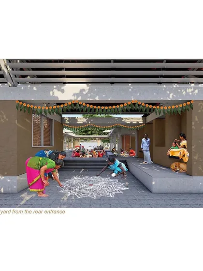 A view from the rear entrance into the courtyard, where women are creating rangoli. This illustrates the day-to-day cultural activities that the space is designed to foster.