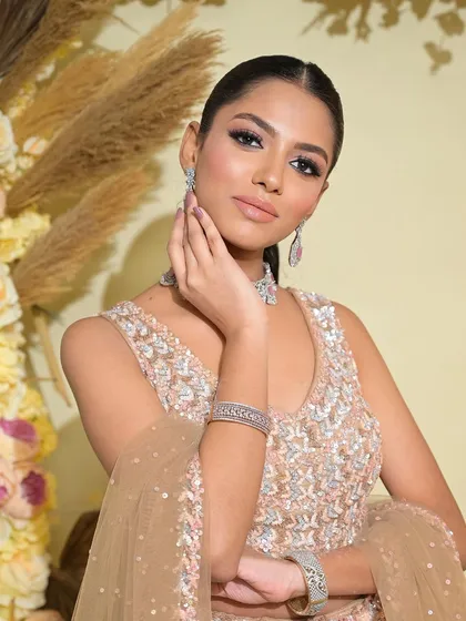 Another angle of this stunning editorial look. The sleek hair and glowing skin create a look that is both high-fashion and incredibly beautiful.