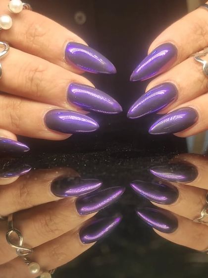 Another angle of the striking purple chrome stiletto nails.