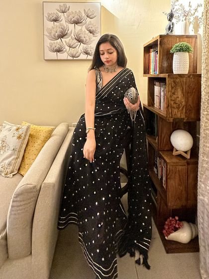 Another angle of the wedding guest outfit. The tassels on the saree's pallu add a playful, traditional detail to the modern sequin design.