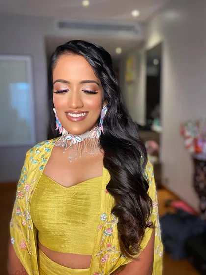 A close-up of Deepanshi's Haldi makeup, with her eyes closed to show the soft, luminous finish.