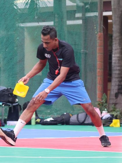 A coach sets up cones for an agility drill. This is where dreams turn into discipline, and discipline turns into dominance.