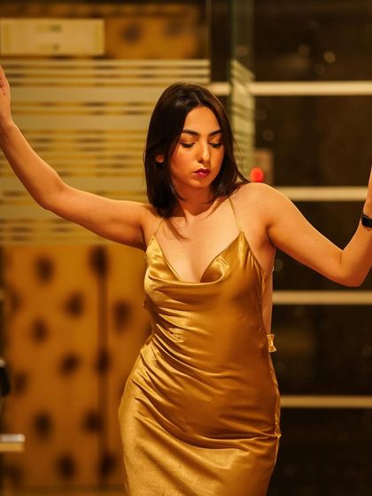 A moody and alluring shot in a golden satin gown, perfect for an elegant evening event.