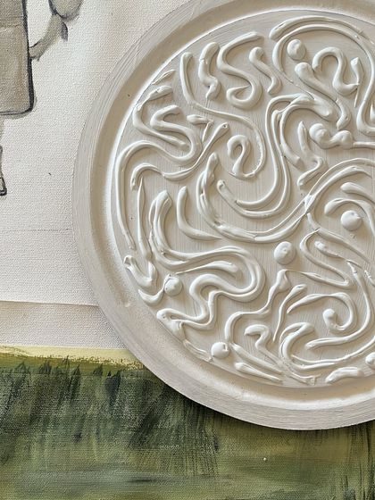 A close-up of one of the two circular textured plaques made for a gallery wall in Mumbai. This one features an intricate, swirling pattern sculpted from texture paste.