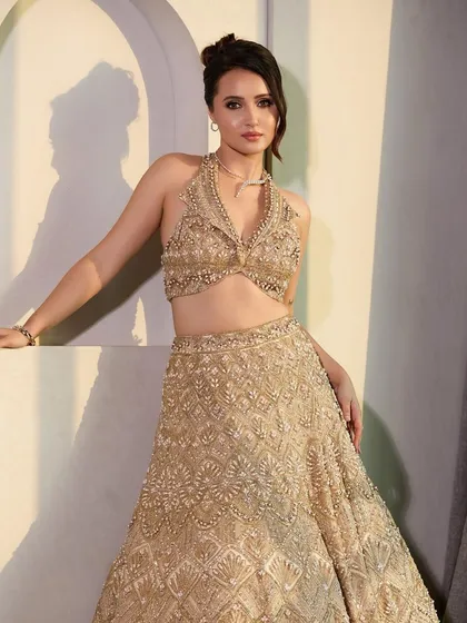Another shot of the Bridgerton-inspired look. The updo is perfectly balanced, adding to the overall grace and elegance of her heavily embellished outfit.