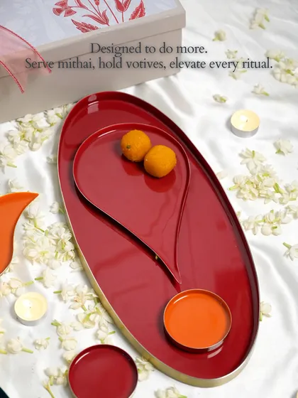 Designed to do more. This image shows the versatility of our Bindu collection, with the large oval tray and smaller plates used together to serve sweets and elevate the ritual of festive hosting.