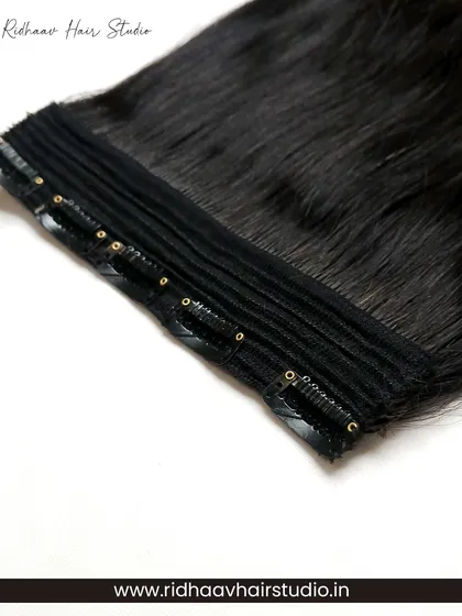 A detailed close-up of the secure clips on our 5-clip ear-to-ear straight extension. These clips ensure a strong hold for all-day wear without damaging your natural hair.