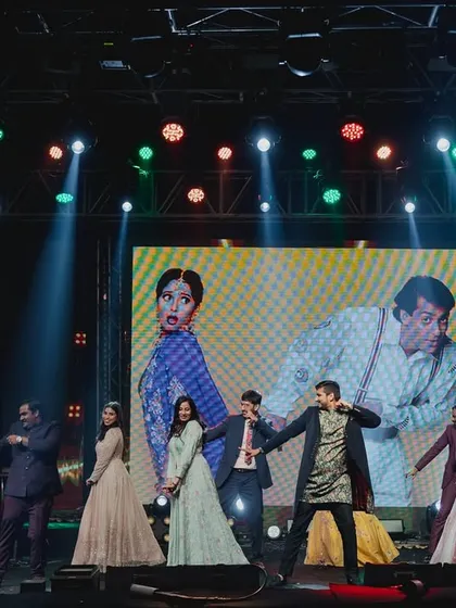 A fun, conceptualized performance by the groom's side. We used a hilarious 'Hum Aapke Hain Koun' themed video on the LED screen as a backdrop to their energetic dance, adding a layer of comedy and nostalgia.