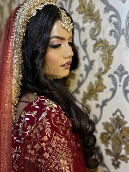 A side profile from a creative shoot, focusing on soft, romantic curls and a flawless base. This look is perfect for demonstrating open-hair bridal styles.