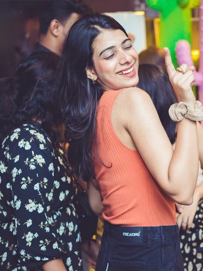 A guest dancing with a smile, enjoying the Thursday night vibe.