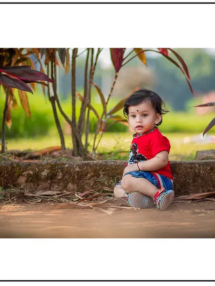 A slightly different angle from the same outdoor session, capturing a direct and engaging look from the child.