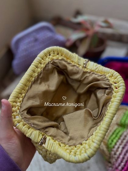 A look inside one of our handmade clutches, showing the smooth satin lining. We pay attention to every detail, ensuring the inside is as well-crafted as the outside.