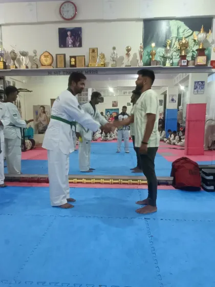 A student receives his green belt.