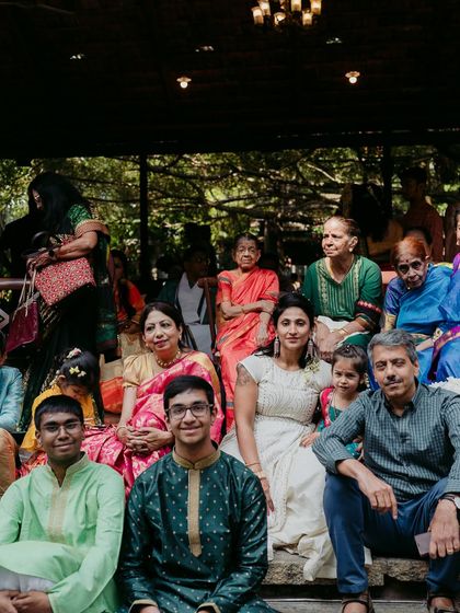 Family and friends gather on the stone steps of the Kalyani for a group photo, a cherished memory of the day.