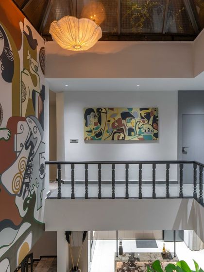 Another perspective of the 'House of the Rising Sun' mural, showing its relationship with a complementary canvas piece on the adjacent wall. We often create multiple artworks within a space to build a cohesive visual story.