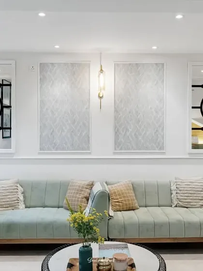 A symmetrical view of the living room sofa, flanked by two ornate mirrors. The combination of textures, patterns, and reflective surfaces creates a visually rich and balanced composition.