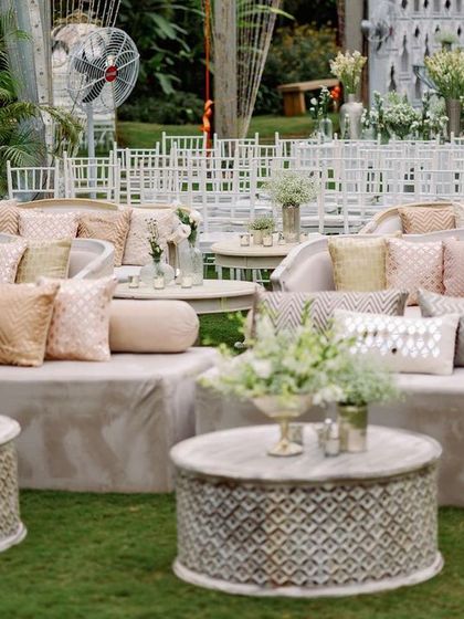 Plush, comfortable seating is key for a long night of celebration. Here, velvet sofas in neutral tones are accented with textured pillows, offering guests a chic spot to watch the sangeet performances.
