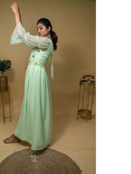 This teal green net georgette dress is the picture of effortless grace. The floor-length silhouette is light and flowing, perfect for dancing the night away.