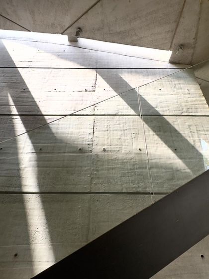 Light falling on a concrete wall from a high window in the 'House of Stories'.