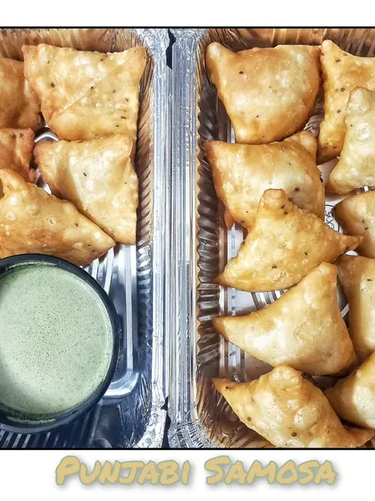 Classic Punjabi Samosas, perfectly spiced and fried until golden brown, served with my homemade green chutney.