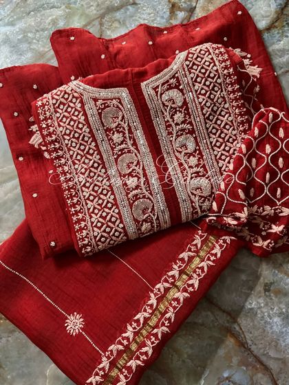 This flat-lay shot captures the full three-piece Sindoori Red set, showcasing the cohesive design and luxurious appeal.