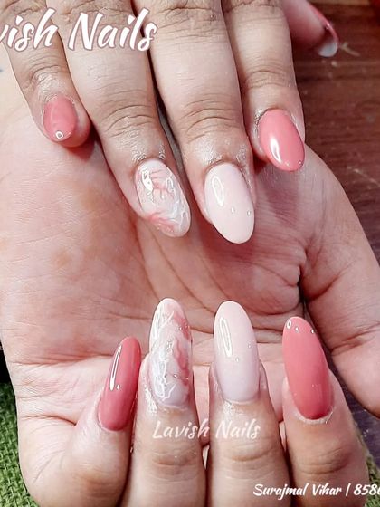 A multi-toned pink set with a delicate pink and white marble accent nail.
