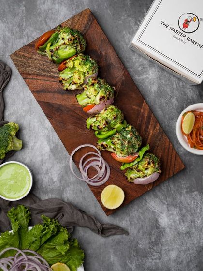 Our Tandoori Malai Broccoli is a unique and creamy appetizer. Fresh broccoli florets are coated in a rich, cheesy marinade and grilled until tender, offering a melt-in-your-mouth experience.
