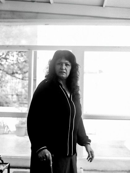 An actor holds a cane, getting into character during a rehearsal.