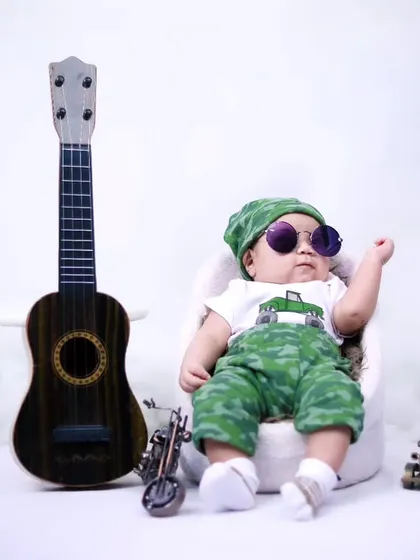 This little guy is ready for his close-up, showing off his cool sunglasses in our studio. We work with babies of all ages, capturing their developing personalities.