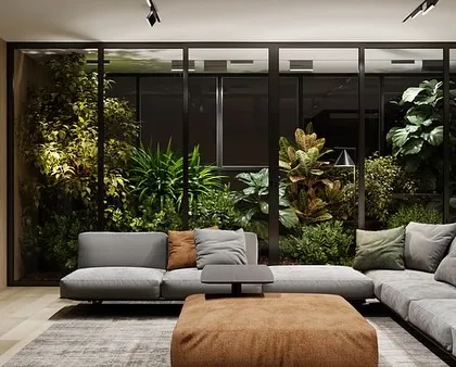 We transformed this living room by installing a floor-to-ceiling glass-enclosed garden. This lush installation acts as a living wall, providing a constant view of vibrant greenery while separating the space with style.