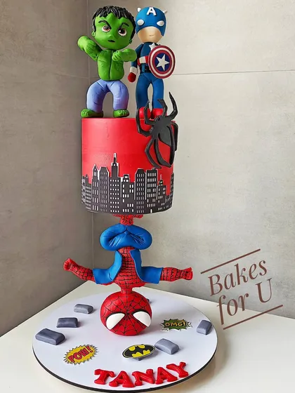 An action-packed anti-gravity superhero cake. This structured design features Spider-Man balancing the entire cake on his head, with Hulk and Captain America on top. All characters are handcrafted from fondant.