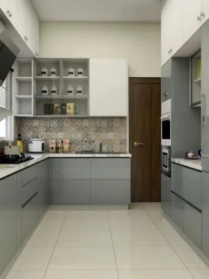 This U-shaped modular kitchen is designed for ultimate efficiency and style. It features sleek, high-gloss grey cabinets, a patterned tile backsplash for a touch of personality, and integrated appliances. The layout provides ample counter space and storage, making it ideal for home cooking in a modern Bangalore apartment.
