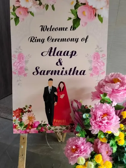 A personalized welcome sign for a ring ceremony. We design custom easel signs with the couple's names and illustrations, which we pair with a beautiful floral arrangement to greet guests as they arrive.